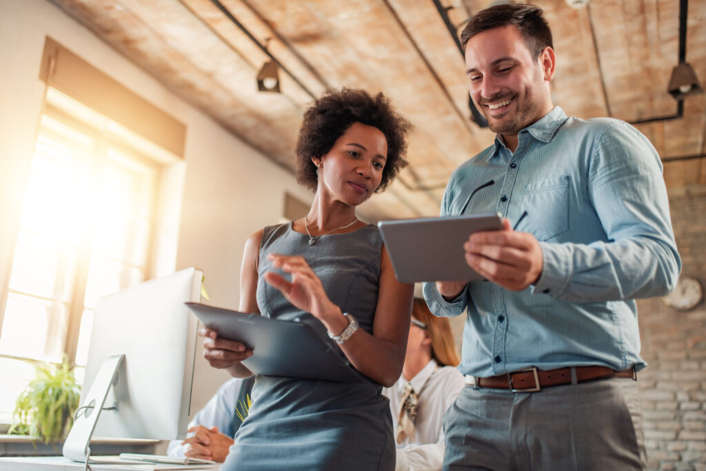 Business owner and executive assistant reviewing tasks