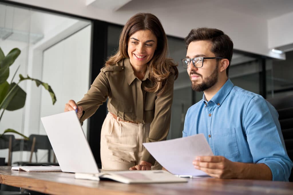 Two assistants work in synergy for their employer.