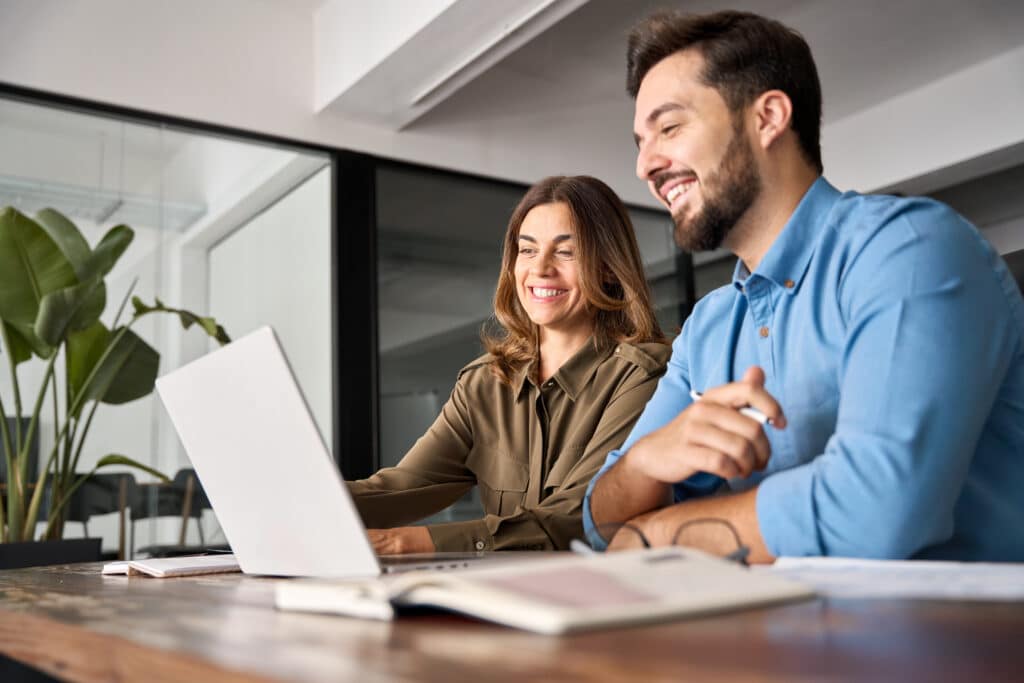 Executive assistant for startup working alongside founder in modern office